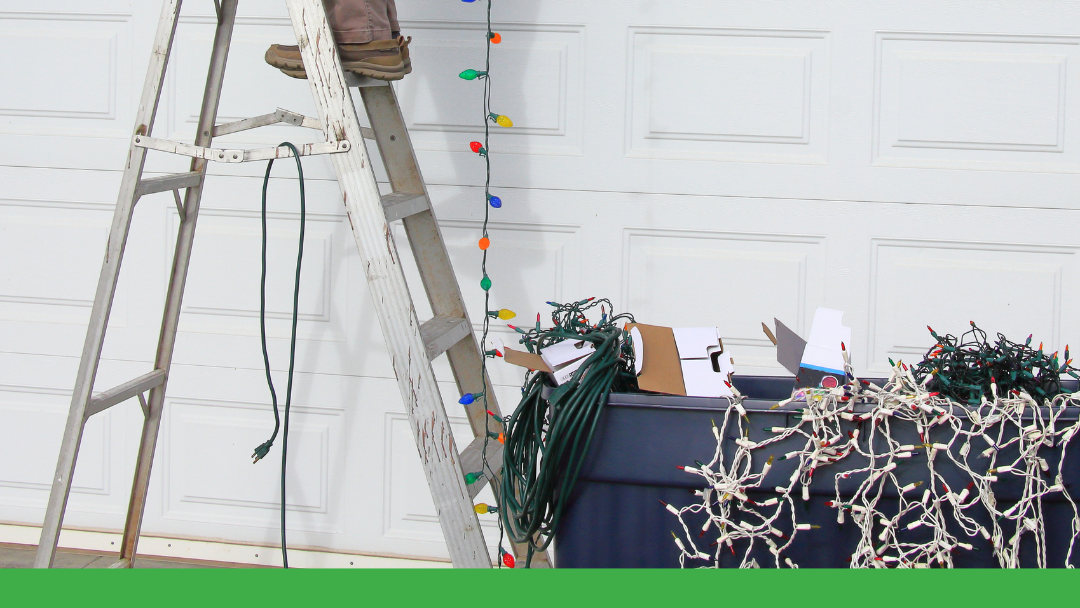person on ladder hanging holiday lights